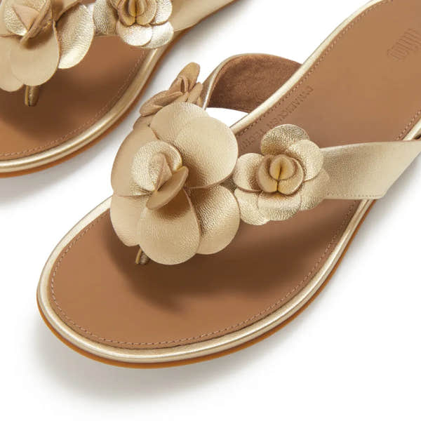 FitFlop A4A-675 Gracie Flower women's platino leather T-bar sandals with floral embellishments and cushioned footbed.
