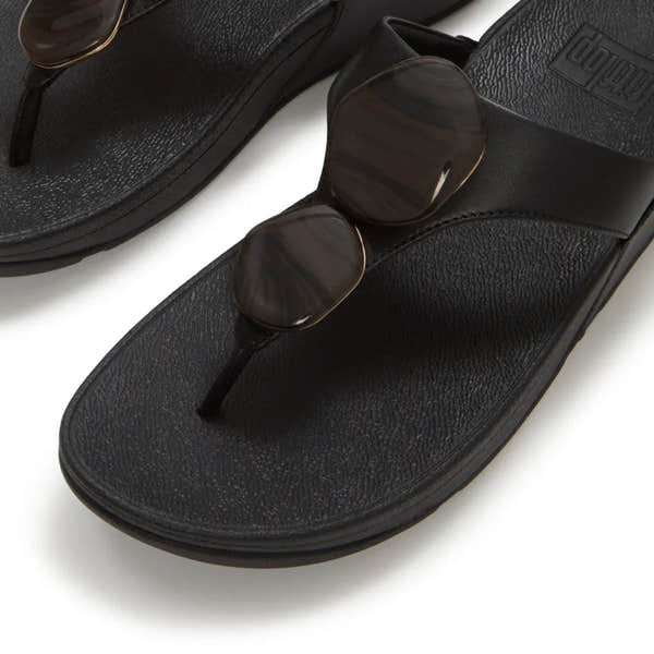 FitFlop Lulu Marbled Stone black T-bar sandals for women with slip-on design and rounded striped sunglasses.