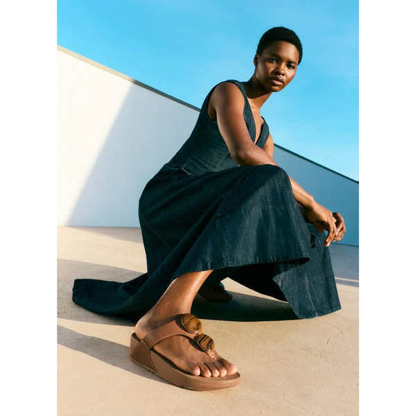 FitFlop Lulu marbled stone deep tan T-strap sandals worn by model, casual summer footwear, open-toe design, comfortable and stylish.