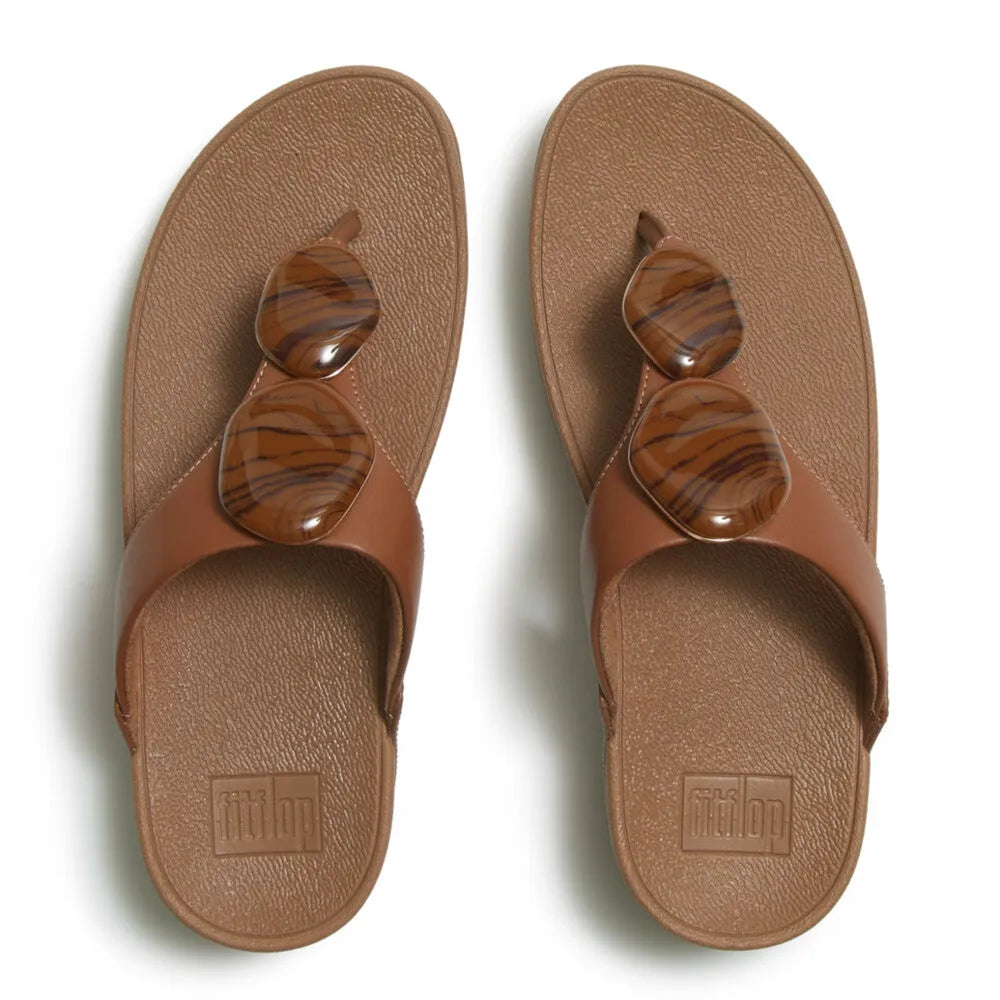FitFlop Lulu marbled stone women's deep tan T-bar sandals with large tortoiseshell-effect hardware, cushioned footbed.