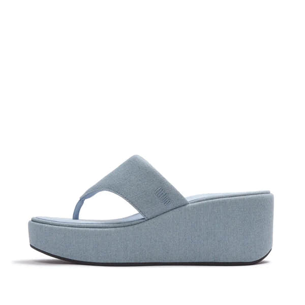FitFlop women’s light denim T-strap platform sandals with cushioned sole and wedge heel.