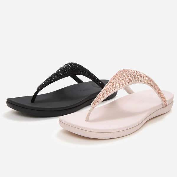 FitFlop Solay Ladies T-Bar Sandals with mixed crystals, one in nude pink with pink crystals, and one in black with black crystals.