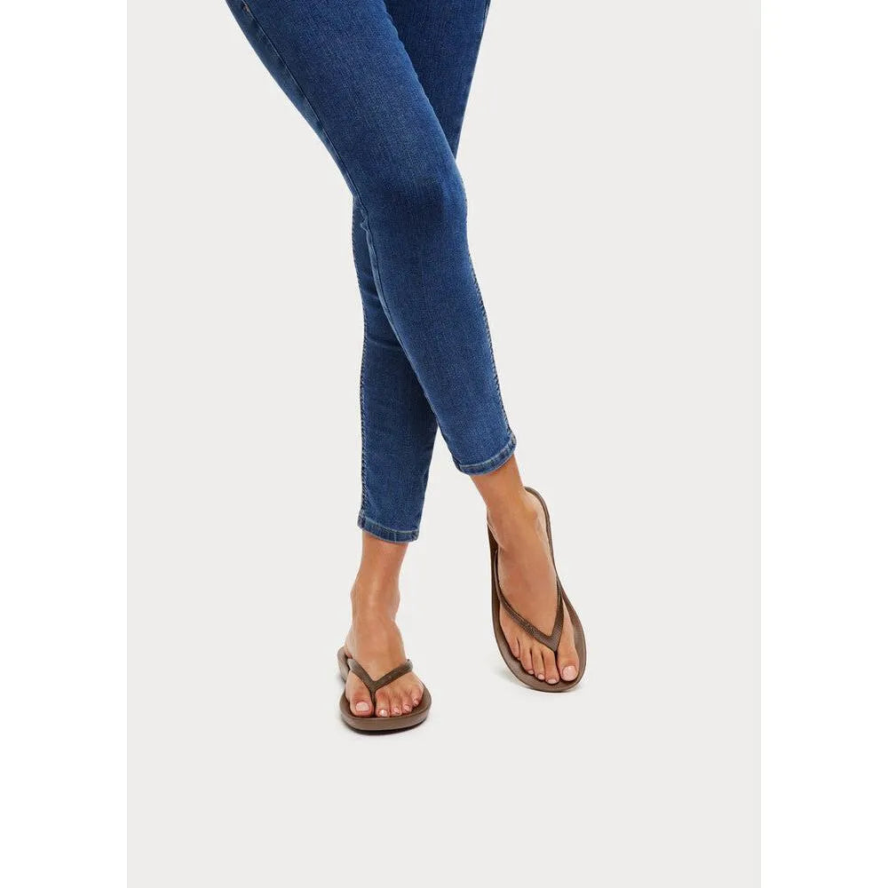 FitFlop E54-012 Iquishion Ladies Bronze T-Bar Sandals with cushioned footbed and sleek design on model's feet.