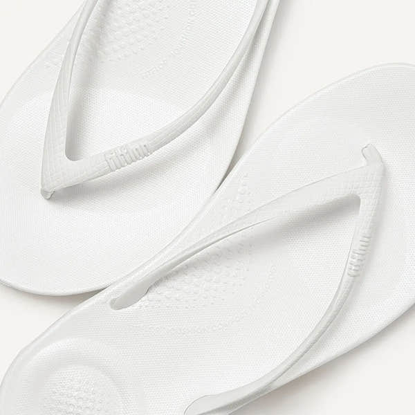 FitFlop E54-194 Iquishion ladies’ urban white T-strap sandals with textured footbed and slip-on style.