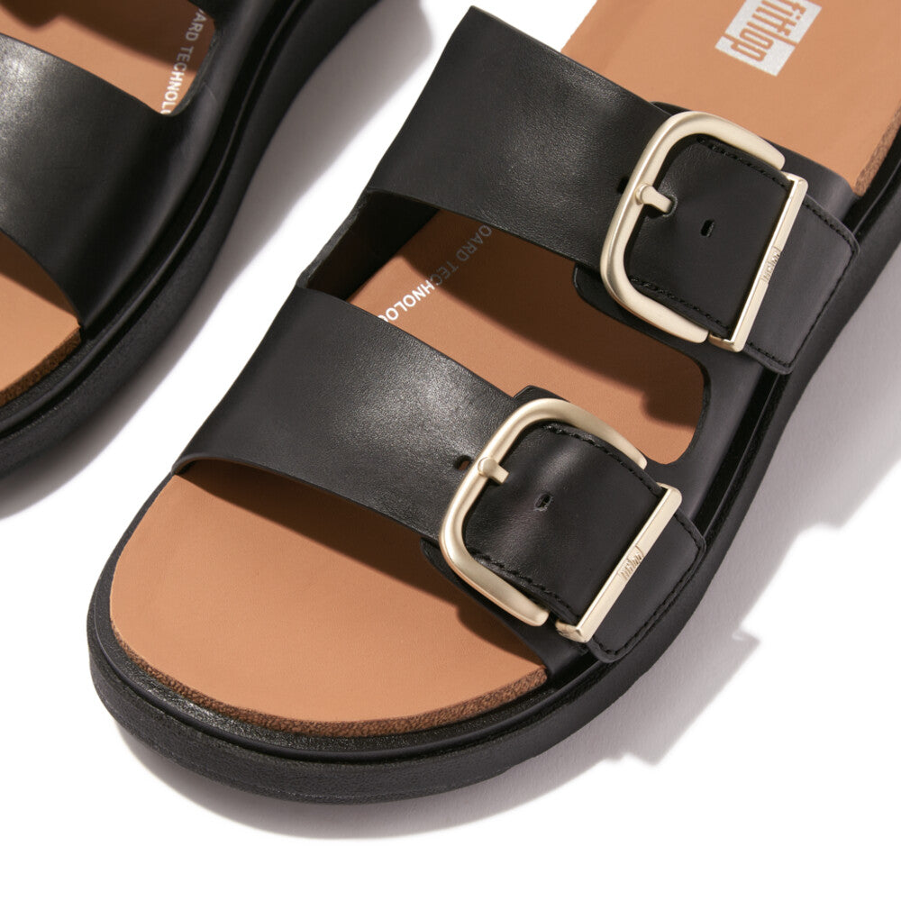 FitFlop HE8-001 Gen-FF women's wide black leather buckle sandals with beige soles.