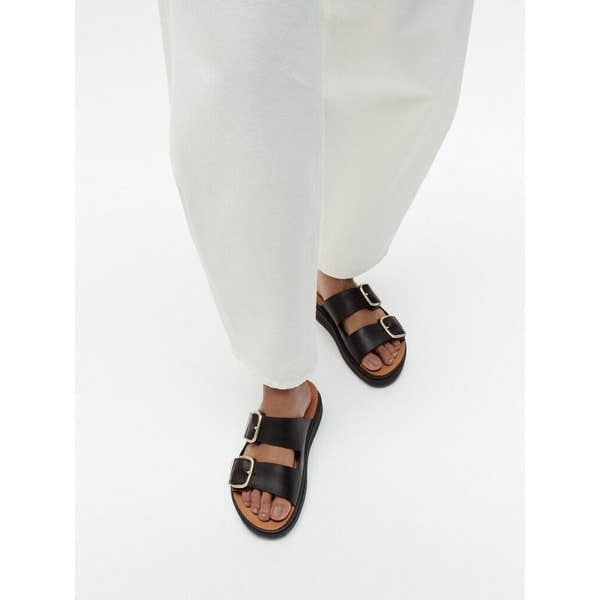 FitFlop HE8-001 Gen-FF women's wide black leather buckle slide sandals with dual straps and gold buckles.