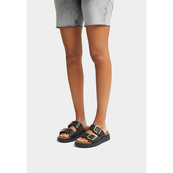 FitFlop HE8-001 Gen-FF women's wide black leather buckle sandals, slip-on design with adjustable buckles, cushioned footbed, casual style.