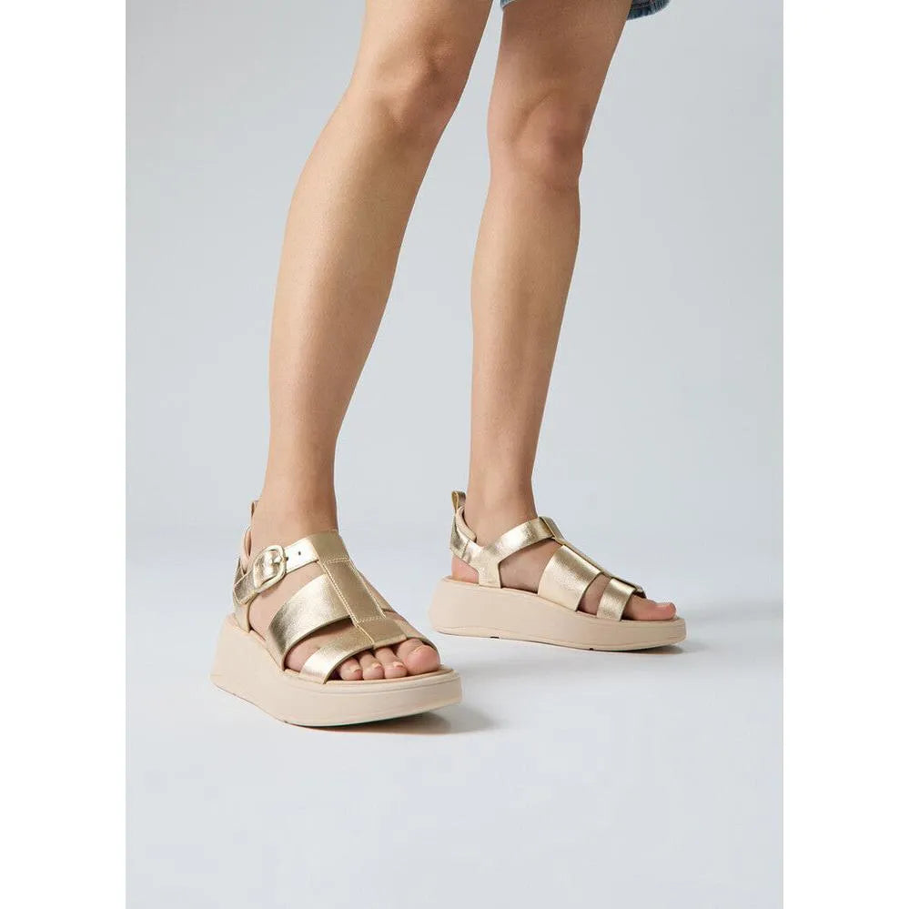 FitFlop HV2-675 F-Mode metallic leather flatform sandals with buckle detail for women.