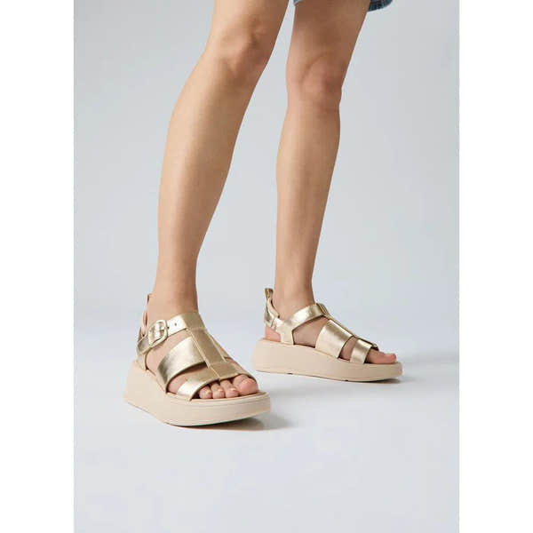 FitFlop HV2-675 F-Mode metallic leather flatform sandals with buckle detail for women.