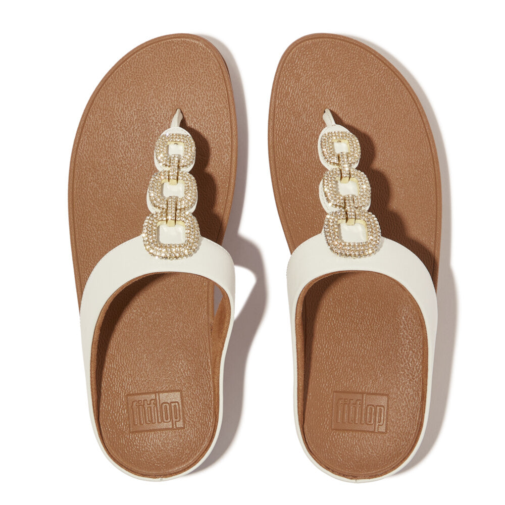 FitFlop HX2-194 Fino Crystal women's white leather slip-on sandals with jeweled chain embellishment.