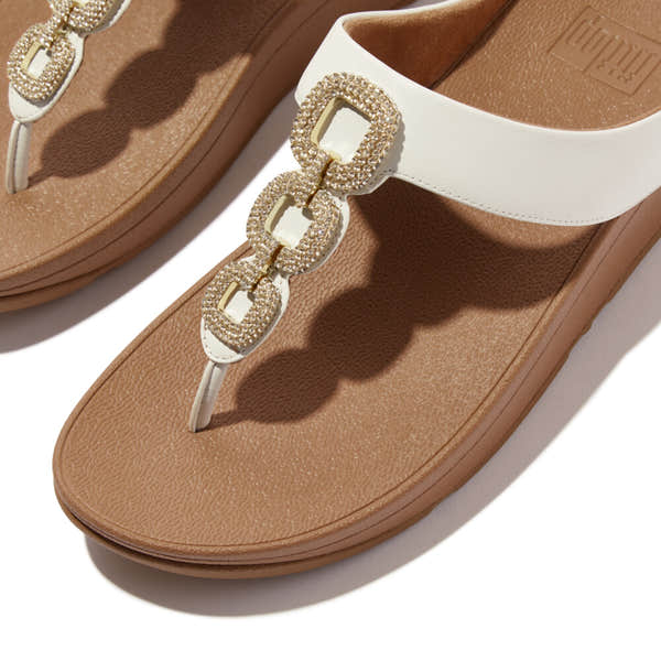 FitFlop HX2-194 Fino Crystal women's white leather slip-on sandals with jeweled buckle detail and tan footbed.