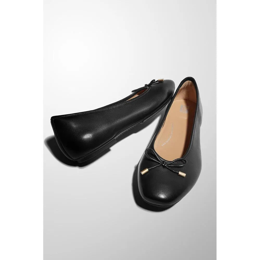 Black leather slip-on ballet flats with bow detail, designed for women, from FitFlop HX8-001 Delicato Bow collection.