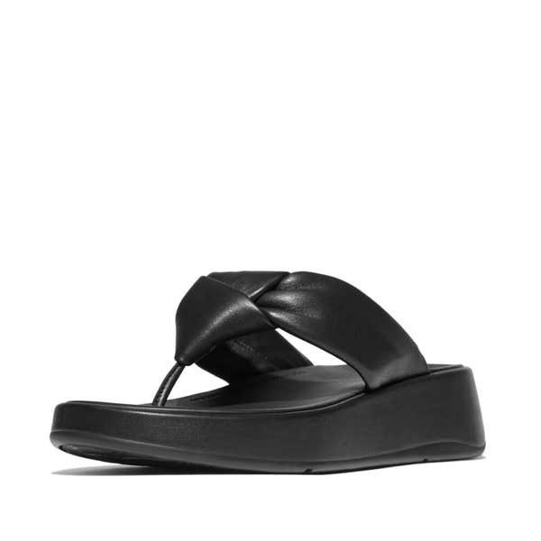 FitFlop IY1-090 F-Mode Knot women's black leather slip-on sandal with twisted knot design, cushioned footbed, and platform sole.