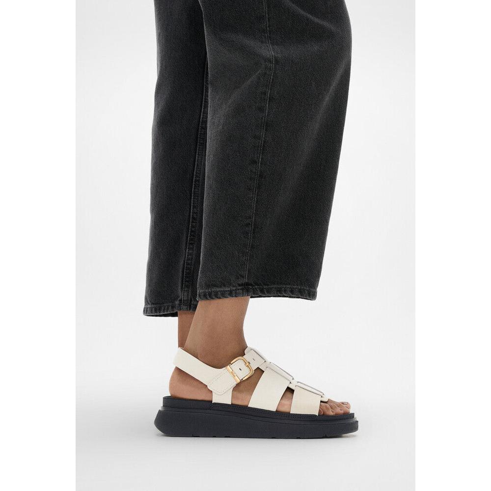 FitFlop IZ1-A99 Gen-FF women's wide beige leather buckle sandals with chunky black sole.