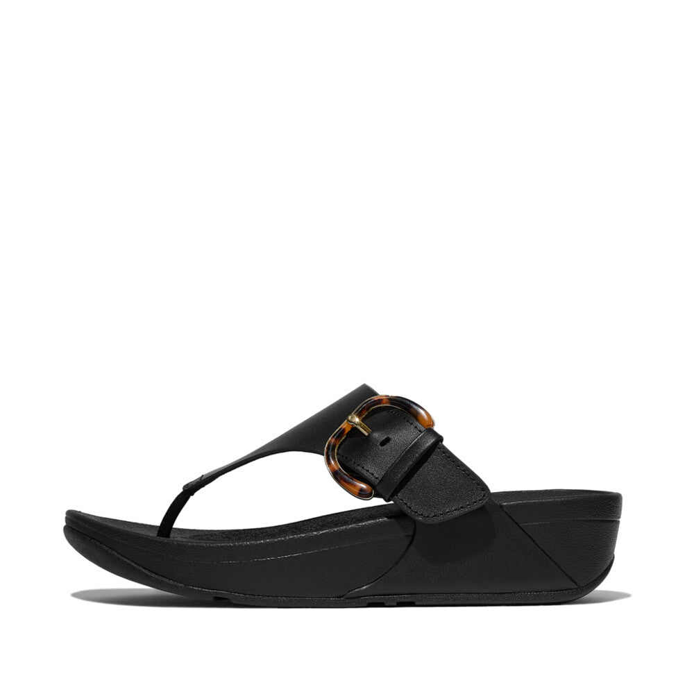 FitFlop Lulu Resin black leather slip-on sandals with adjustable buckle, cushioned footbed, and platform sole.