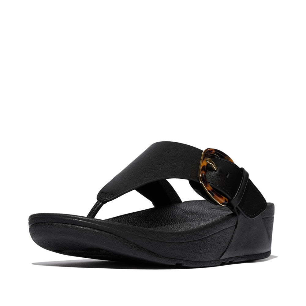 FitFlop Lulu Resin black leather slip-on sandal with tortoise shell buckle, ergonomic footbed, and open toe design.