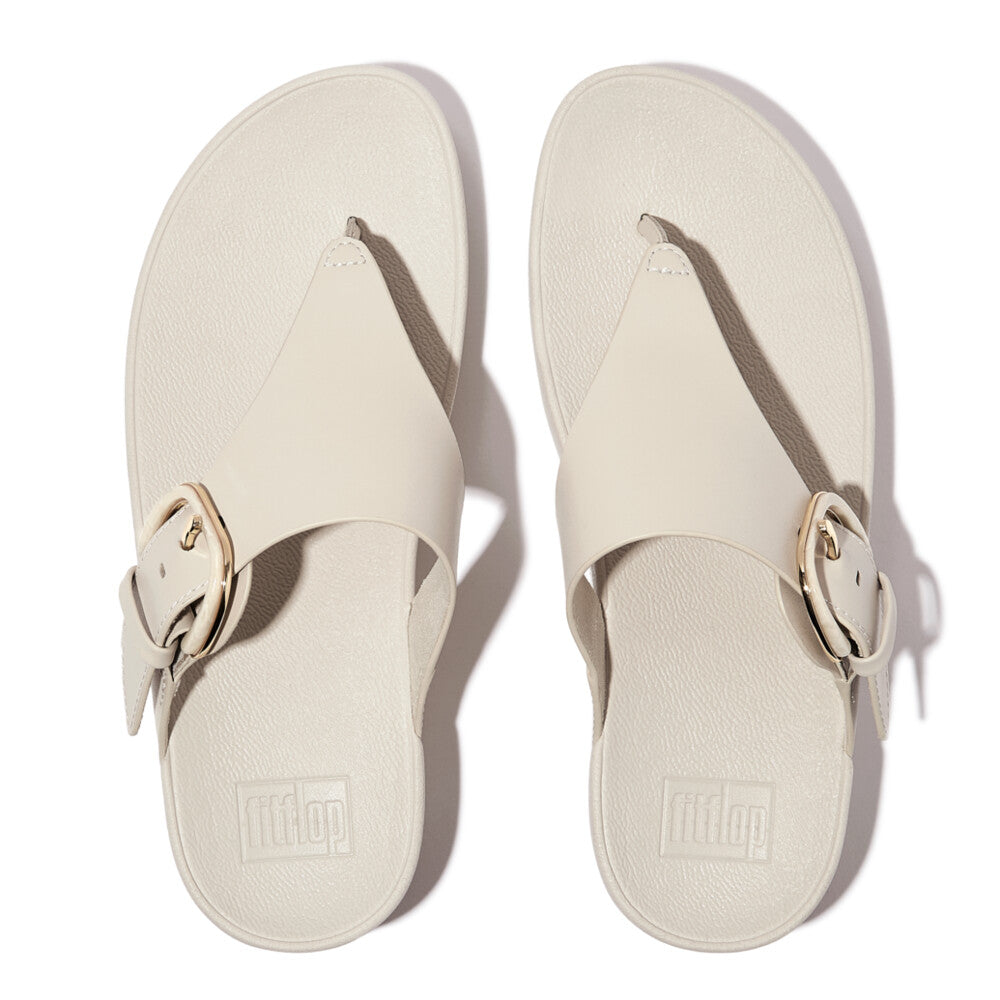 FitFlop Lulu Resin beige leather slip-on sandals with wide straps and gold buckle, cushioned footbed, women's casual footwear.