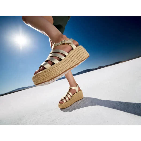 FitFlop JF5-675 platform espadrille sandals for women, platinum leather T-strap design with wedge sole on white desert landscape.