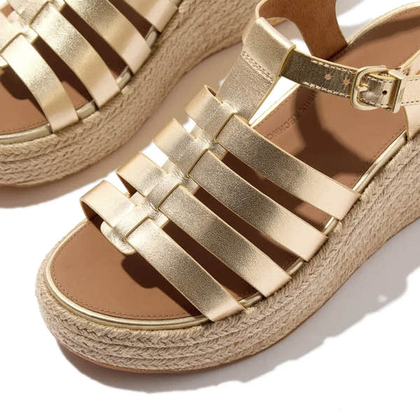 FitFlop JF5-675 platform espadrille sandals with gold leather T-strap, adjustable ankle strap, and woven wedge sole.