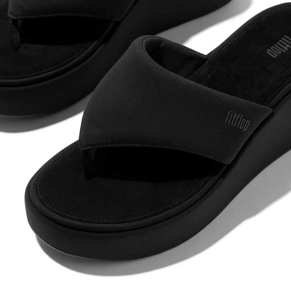 FitFlop JF8-090 women's narrow black platform slip-on sandals with wide strap and cushioned sole.