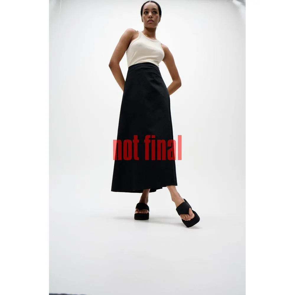 FitFlop JF8-090 platform women's narrow black slip-on sandals on a model with a white background.