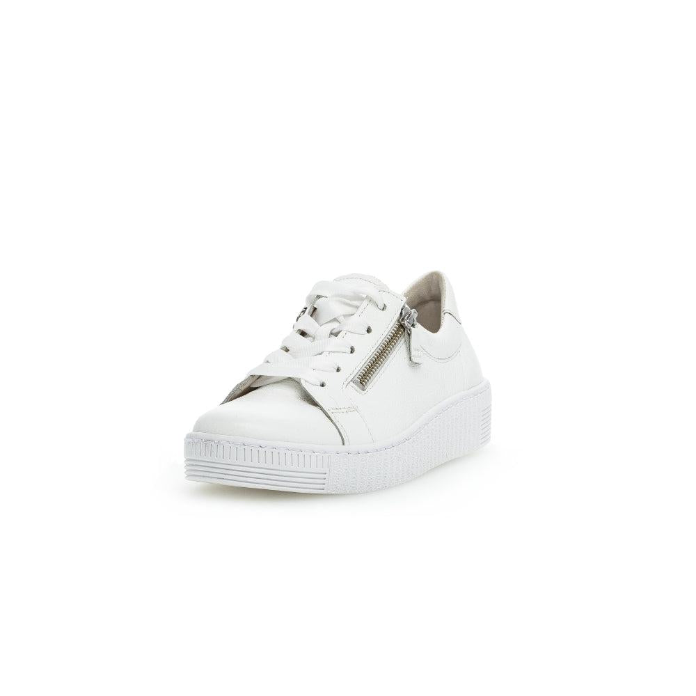 White leather women's sneakers with lace-up front, side zipper, and chunky rubber sole.