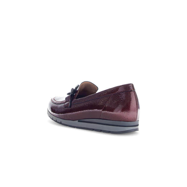 Gabor women's burgundy red and black grained patent leather slip-on loafers with bow detail and cushioned sole.