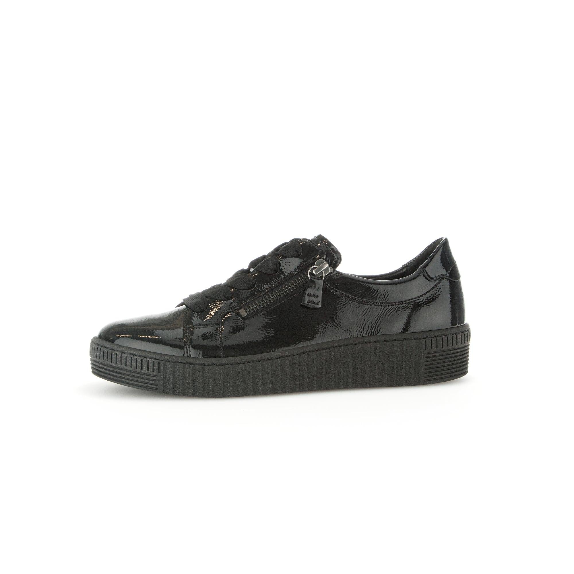 Gabor Ladies' black patent leather trainers with zip & lace-up design, chunky sole, soft finish, and stylish sneaker style.