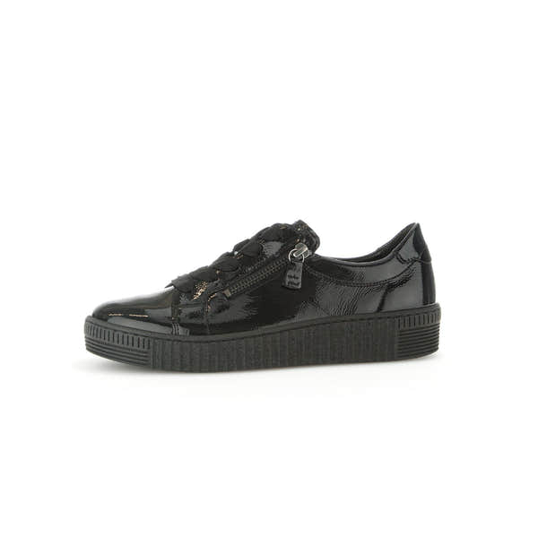 Gabor Ladies' black patent leather trainers with zip & lace-up design, chunky sole, soft finish, and stylish sneaker style.