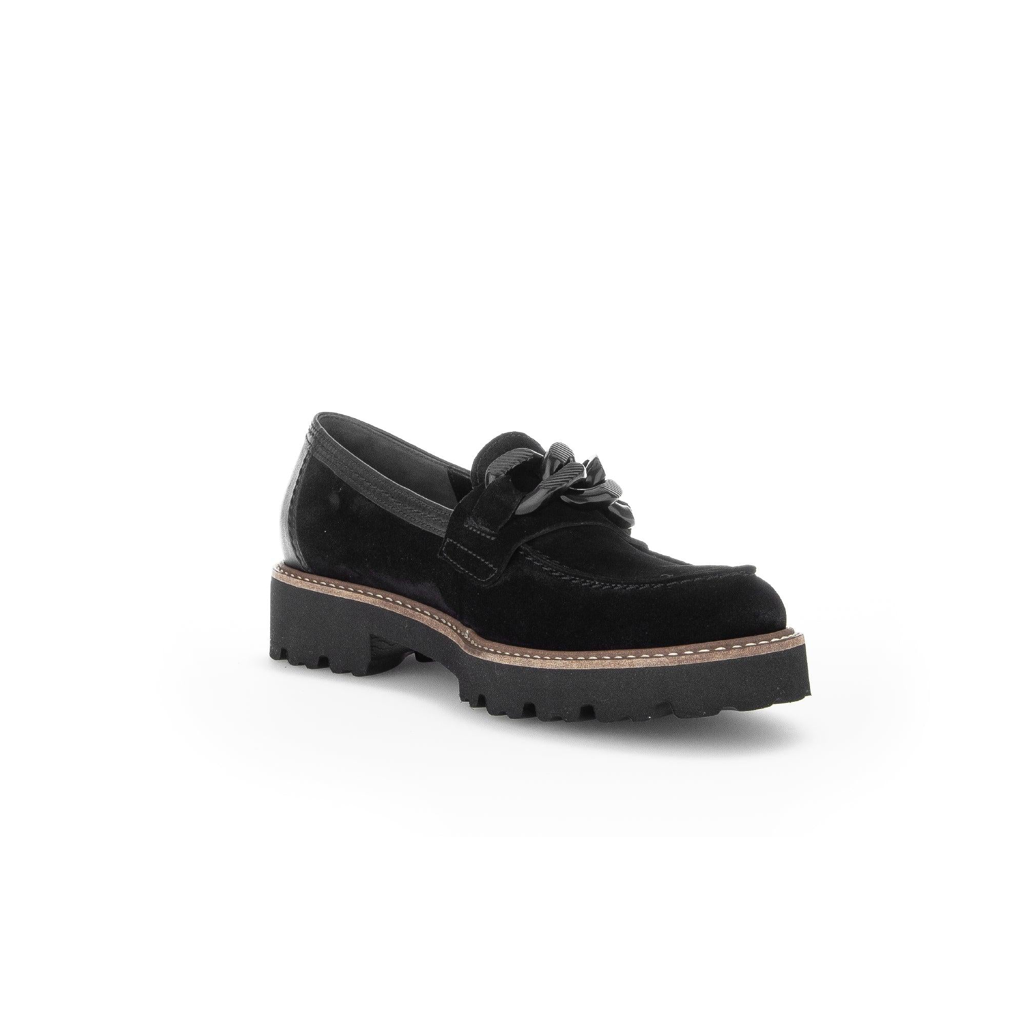 Black suede slip-on loafers for women with decorative bow, chunky sole, and clean design.