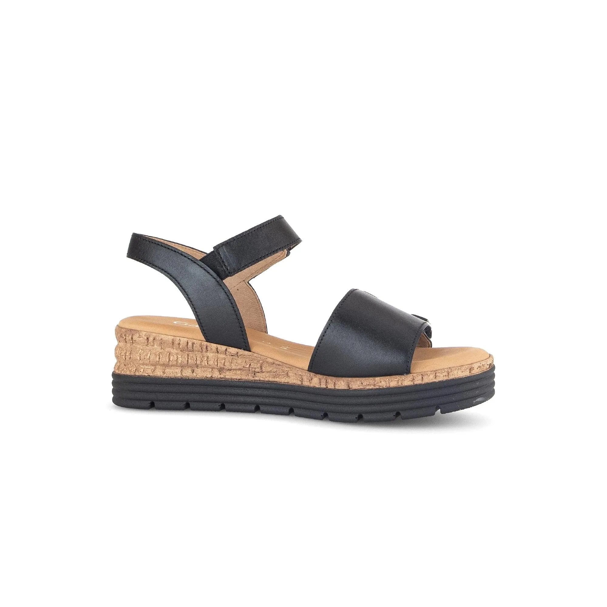 Black leather sandals with touch fastening, cork-wrapped wedge sole, and sturdy black rubber base for comfort and style.