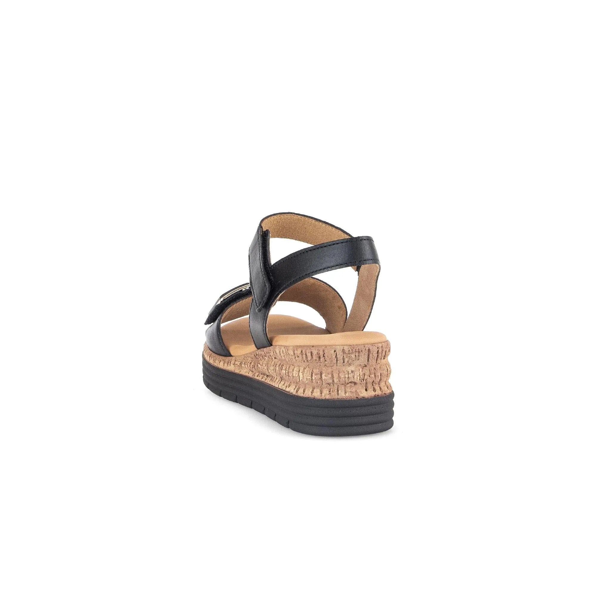 Black leather touch-fastening wedge sandal with a textured cork-style platform and black rubber sole.