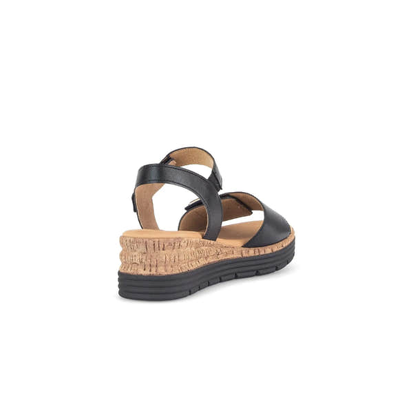 Black leather touch fastening sandal with cork wedge sole and cushioned footbed, designed for ladies.