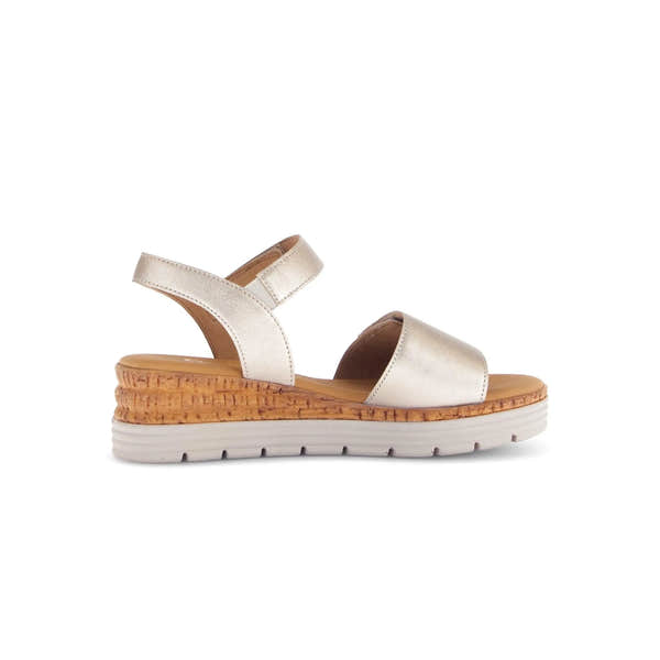 Beige leather touch fastening sandals with cork wedge heel and white rubber sole.