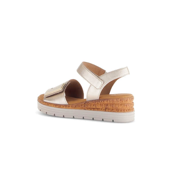 Beige leather sandals with touch fastening, cushioned sole, and a stylish wedge design. Perfect for summer outings.