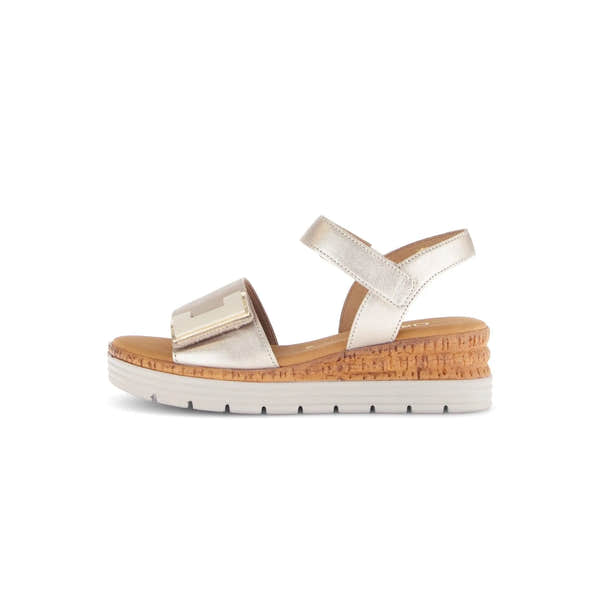 Beige leather sandals with touch fastening, metallic accents, and a cork wedge sole for comfort and style.