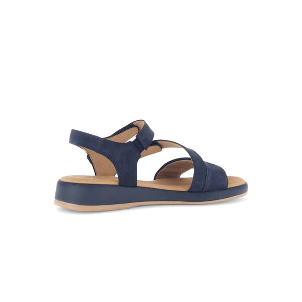 Blue nubuck sandals with touch fastening, featuring stylish cross straps and a comfortable flat sole.