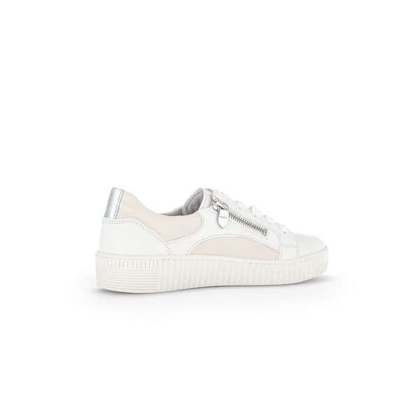 White leather trainer with beige accents, silver zip detail, lace-up, and chunky sole.