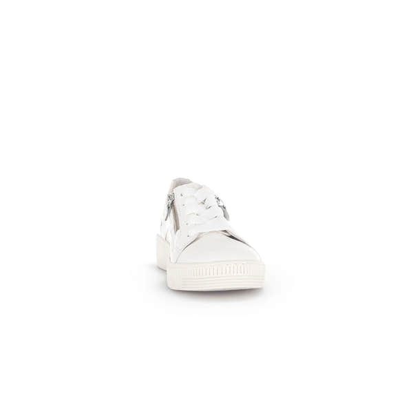 White leather women's trainer with lace-up front, silver zipper detail, padded heel, and chunky rubber sole.