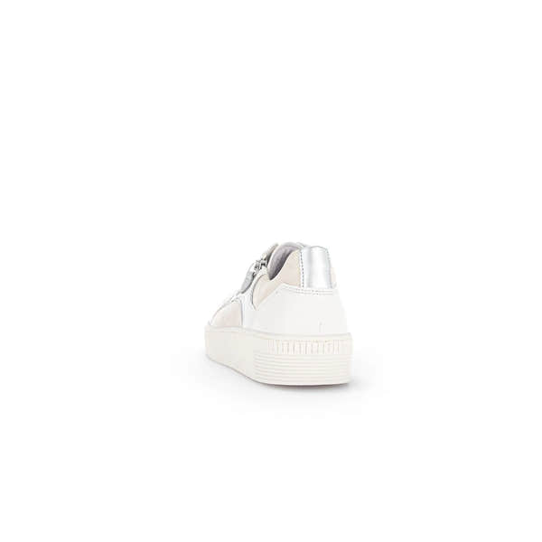 White leather trainers with silver accents, zip and lace details, featuring a textured sole and stylish design.