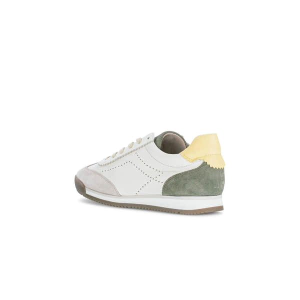 White and green suede and leather lace-up trainer with beige laces, yellow heel tab, perforated details, and a white sole.