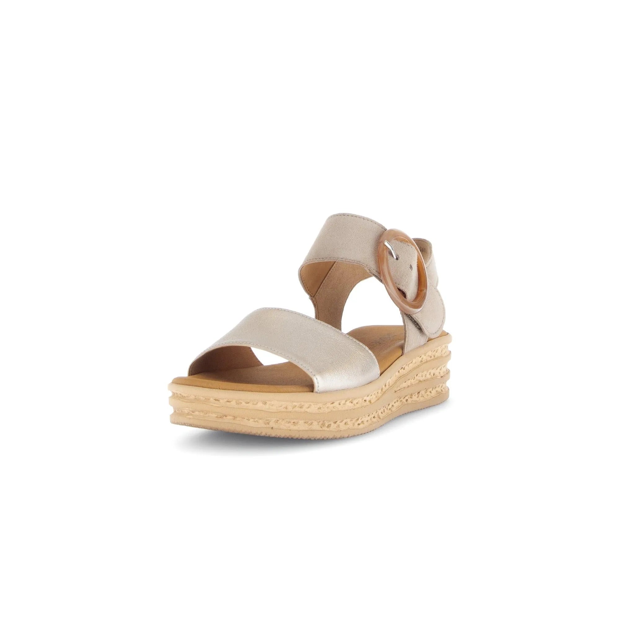 Beige leather touch fastening sandal with chunky layered sole and large circular buckle detail.