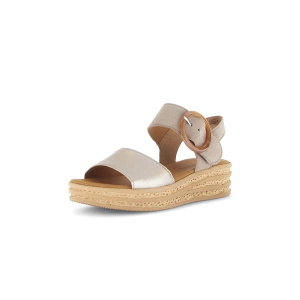 Beige leather touch fastening ladies sandal with a chunky layered sole and large circular buckle detail.