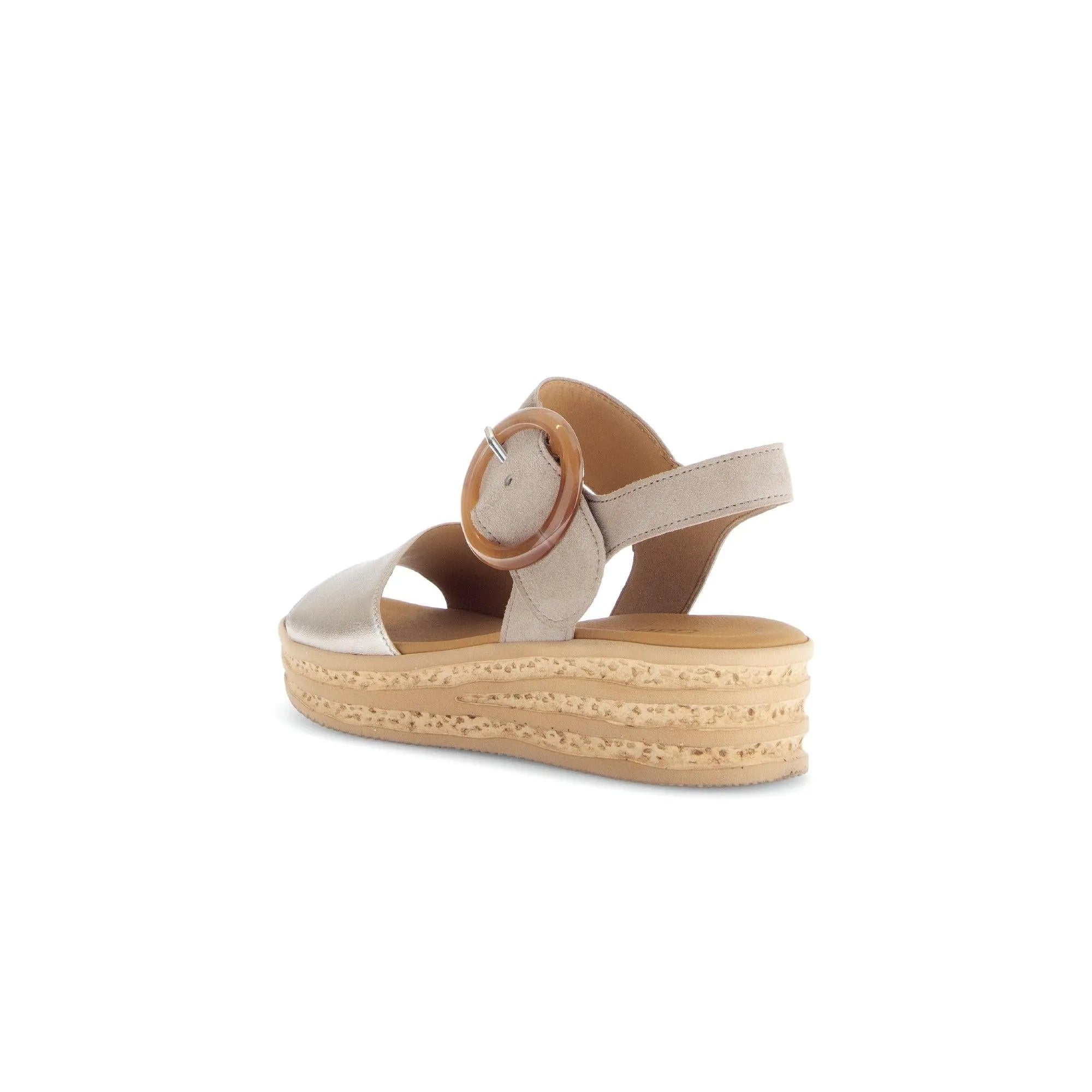 Beige leather touch fastening sandals with a circular buckle and textured platform sole. Elegant and stylish design.
