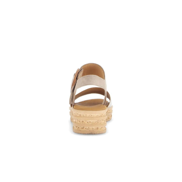 Beige leather sandals with touch fastening, open back, and layered cork-effect sole for a stylish summer look.