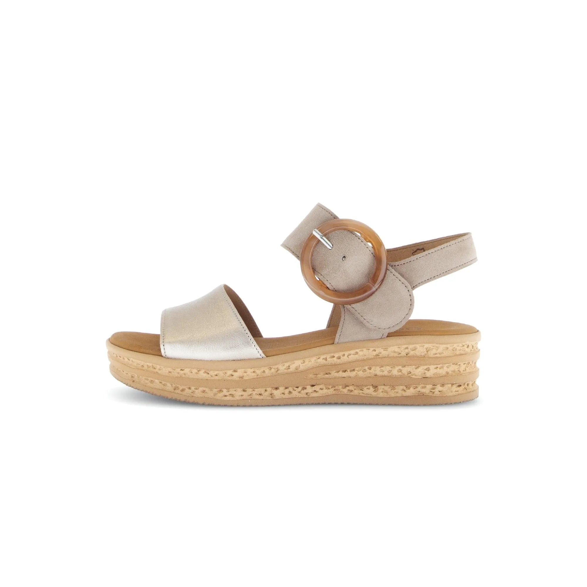 Beige leather sandals with a metallic strap, touch fastening, and a cork sole, featuring a round wooden buckle detail.
