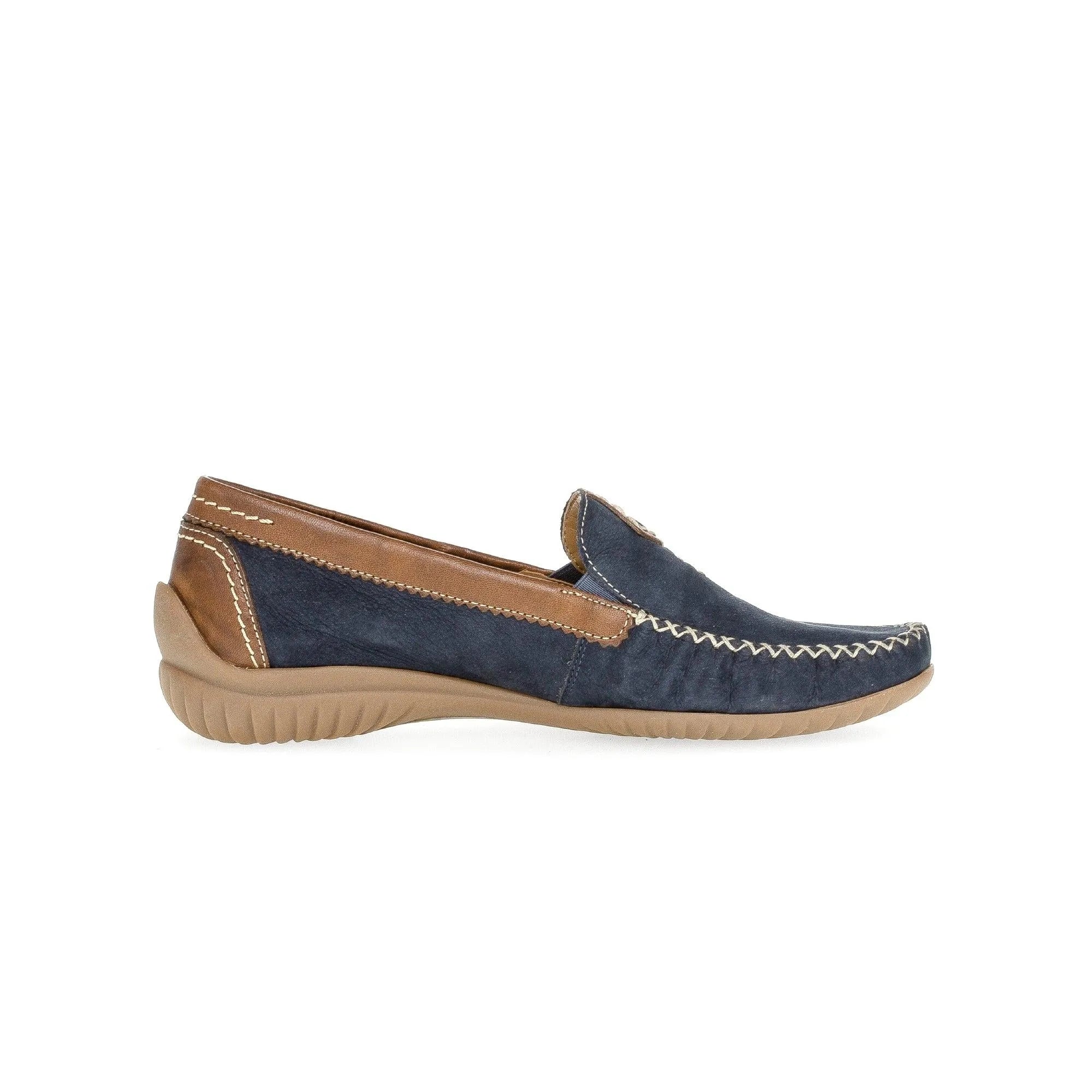 Blue nubuck slip-on shoes with tan leather accents, stitching details, and a beige rubber sole.