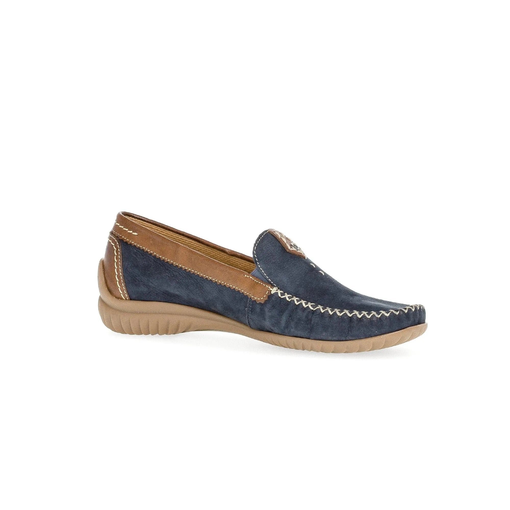 Blue nubuck slip-on shoes with tan accents and white stitching, featuring a beige flexible sole.