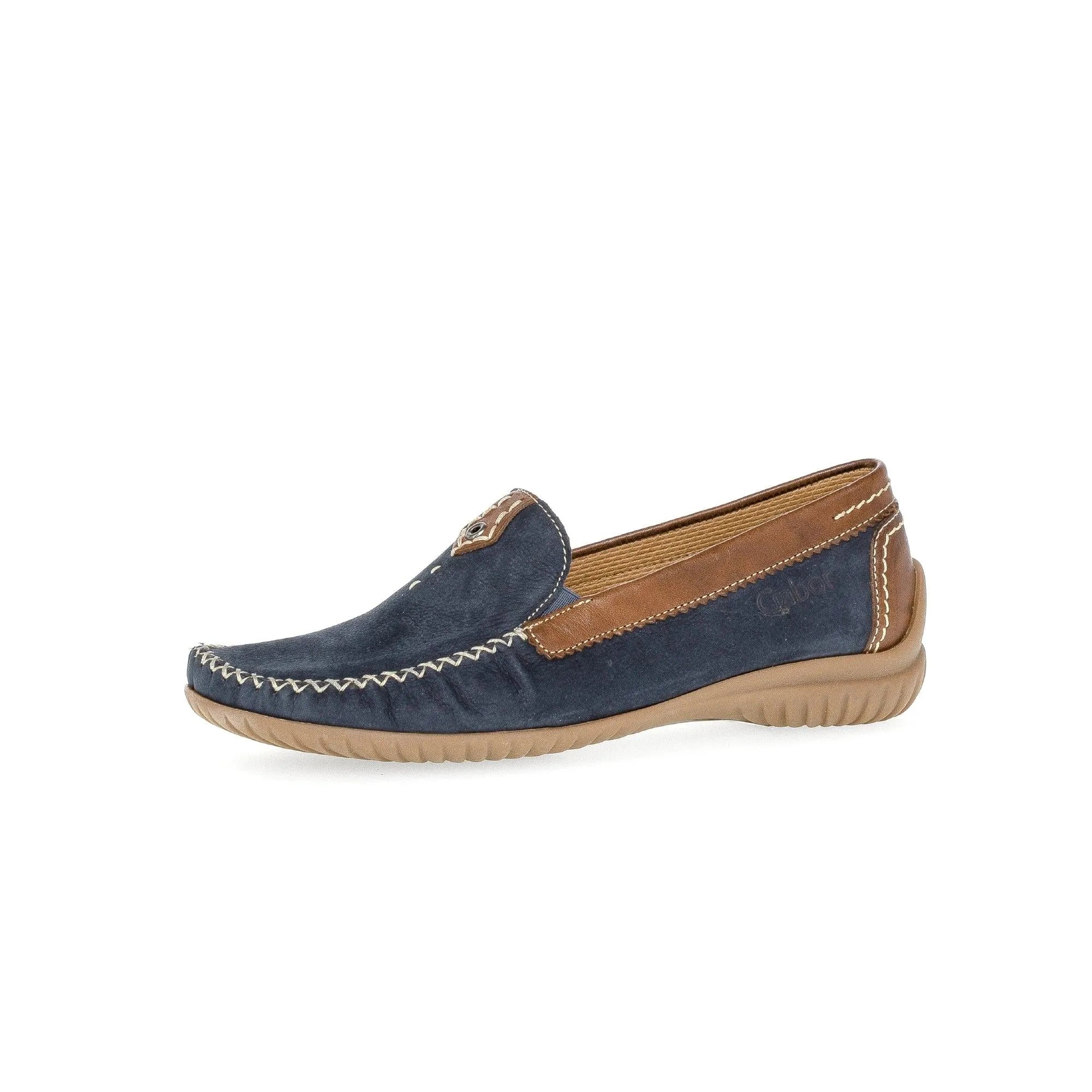 Blue nubuck slip-on shoes with brown leather accents, white stitching, and a beige rubber sole.