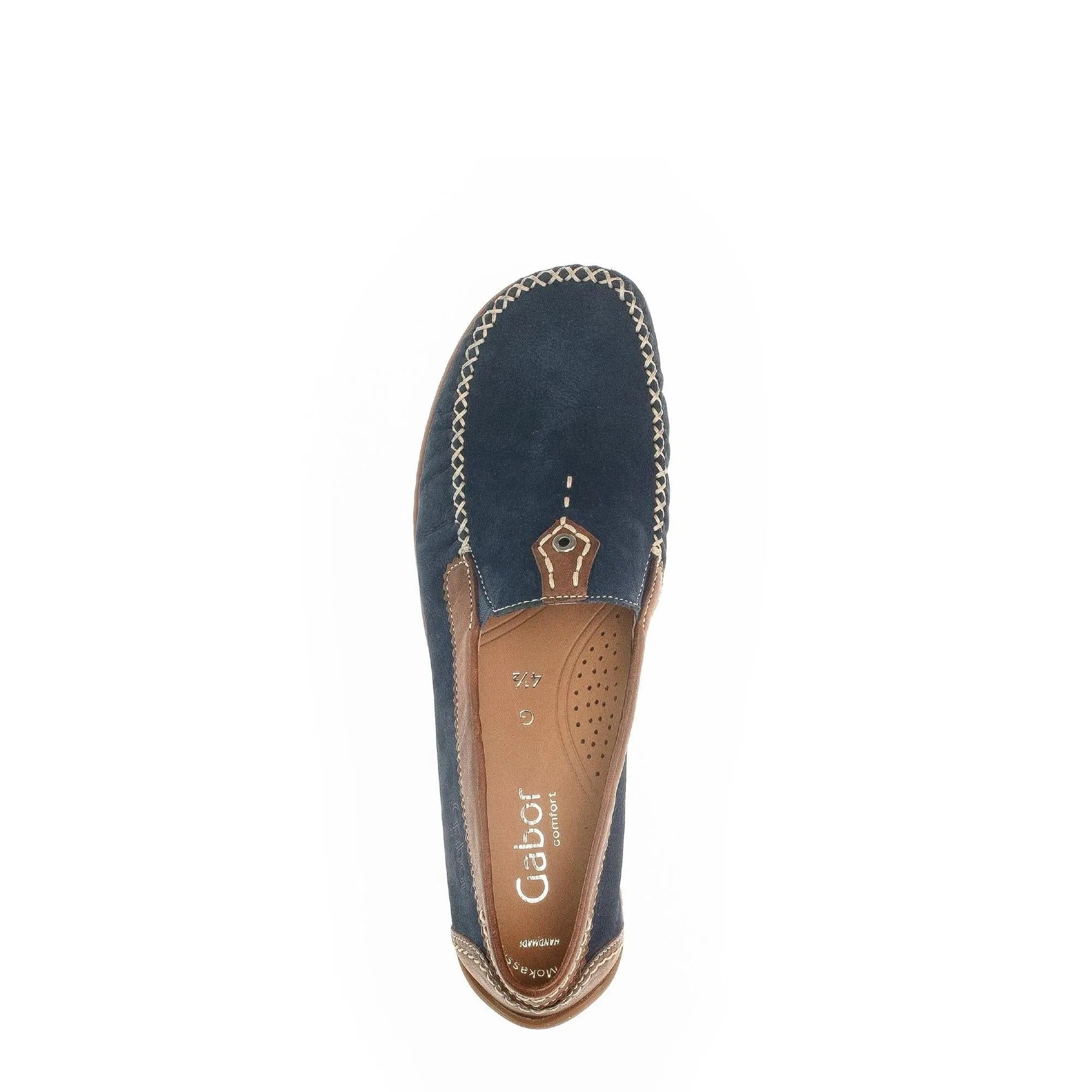 Blue nubuck slip-on shoe with tan leather accents, stitched detailing, and a cushioned interior; casual, comfortable style.
